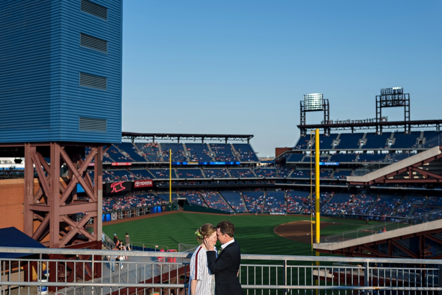 A couple share a moment in front of the Phillies ball field.